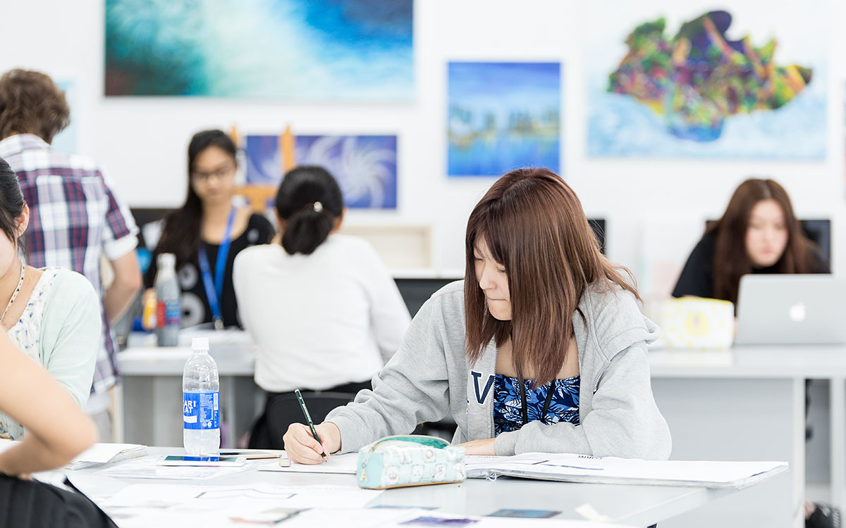 A female OFS Senior High School student taking note during lesson in the classroom