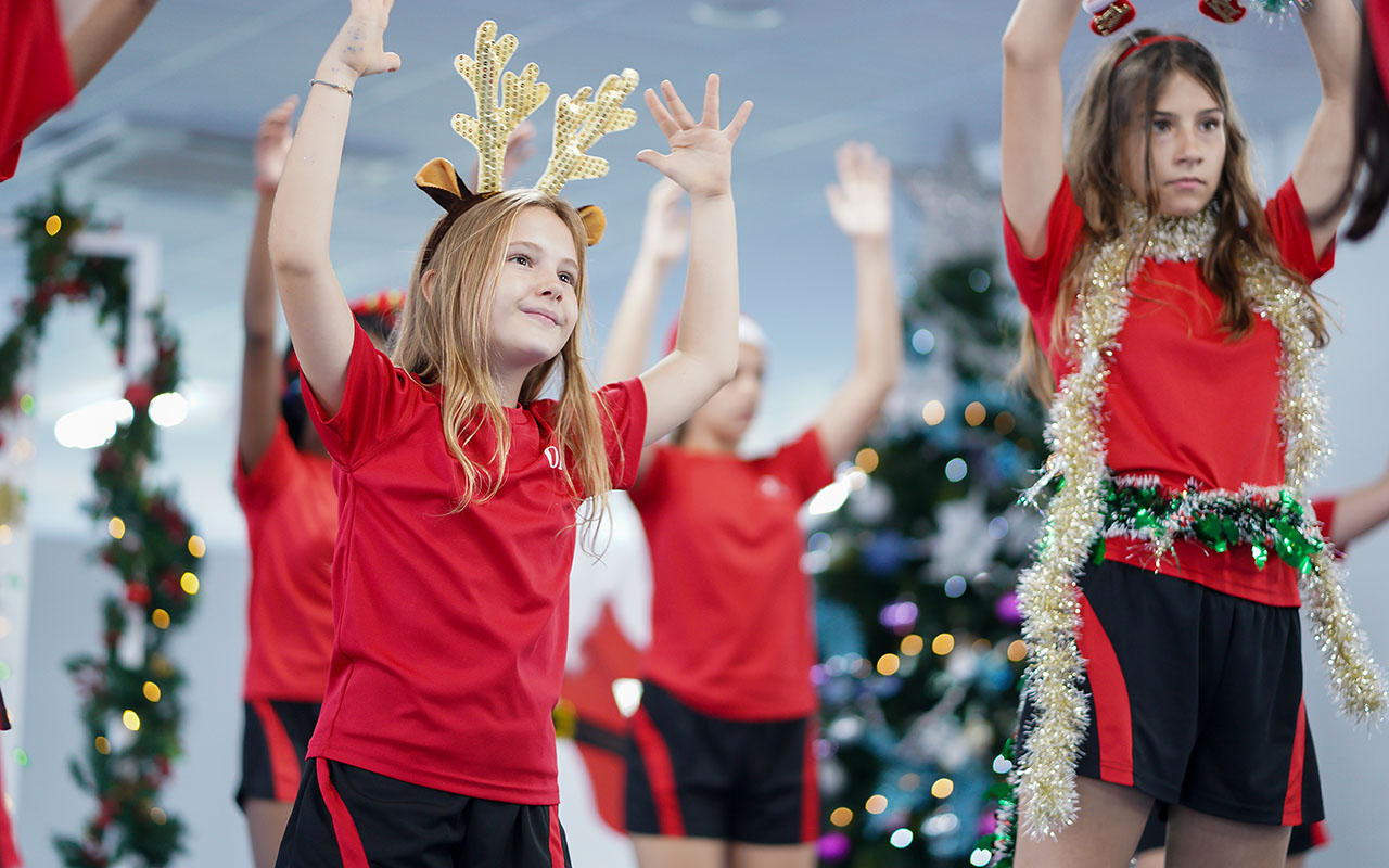 OFS Middle School students singing and dancing a christmas tune during Parent Association Christmas Themed Coffee Morning