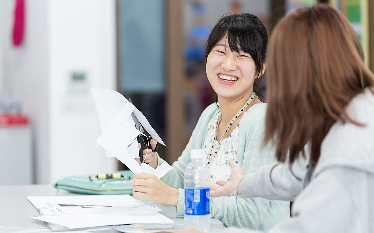 Two female OFS Senior High School students in the art class