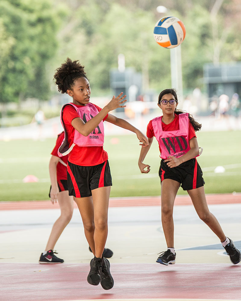OFS Middle School girls netball team playing against another school