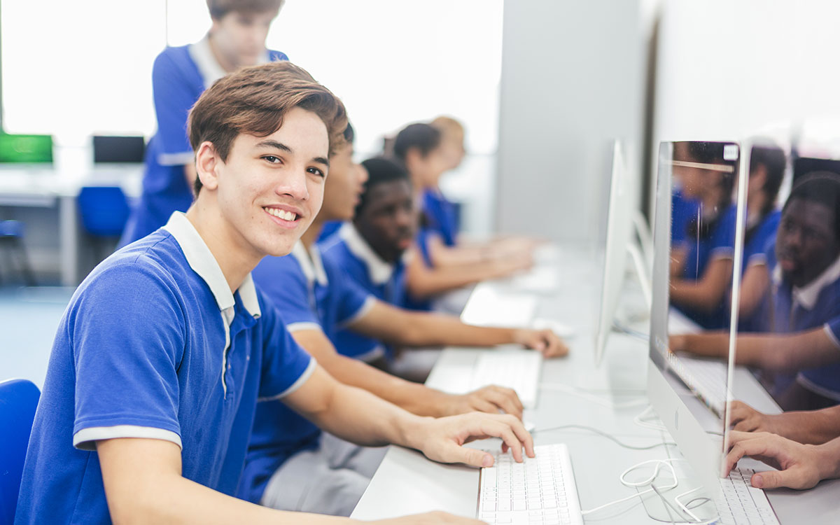 OFS Junior High School student sitting in front of the computer