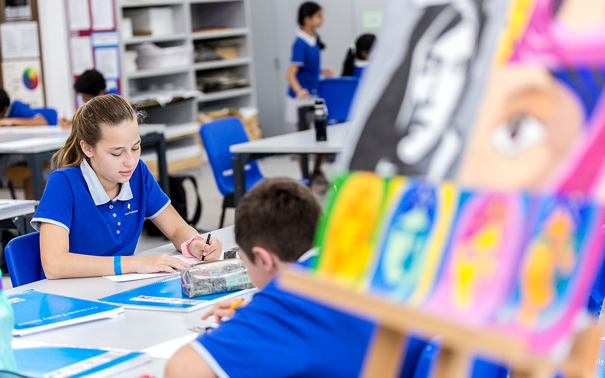 A female and male OFS Middle School students drawing during art lesson in the OFS art room
